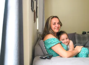 Adele and her daughter in their home