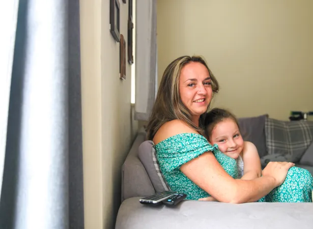 Adele and her daughter in their home