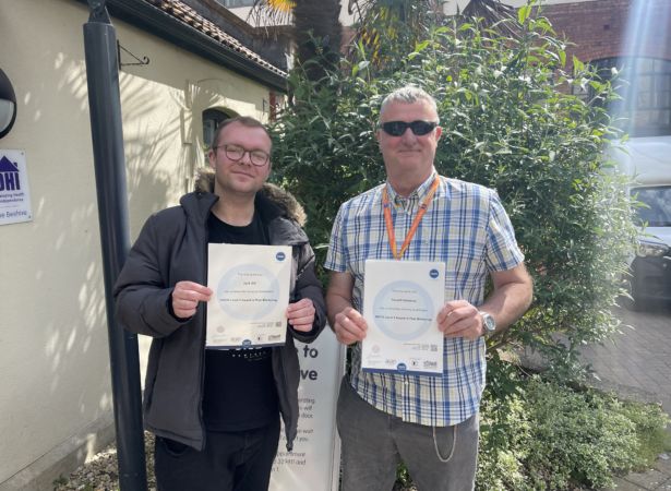 DHI peers Jack and Ron collect their Level 2 peer mentoring awards